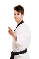 Young man in kimono excercising martial arts, isolated on white