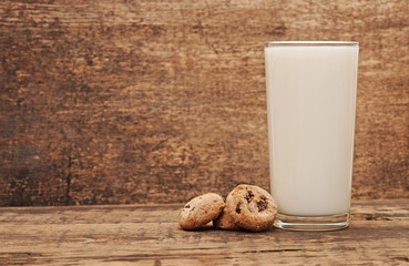 delicious chocolate cookies staked around glass of fresh milk