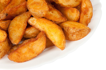 Fried potato wedges isolated on white background