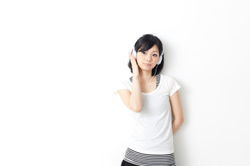 Fototapeta premium attractive asian woman listening music