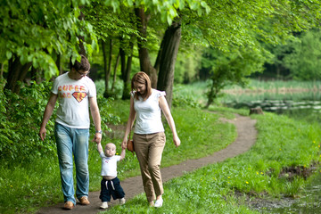 Fototapeta premium Portrait of happy young family with baby boy in spring park
