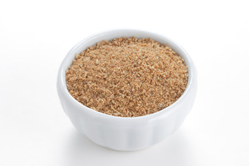 Cumin ground  in a white bowl on white background.