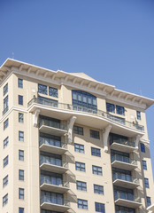 Balconies on Stucco Condo Building Under Blue Sky