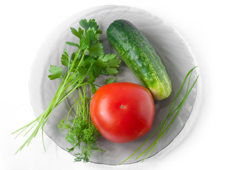 Tomato, cucumber, celery, garlic and dill on a plate