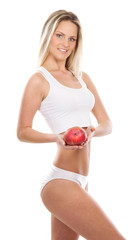 A young and sexy blond Caucasian woman holding an apple