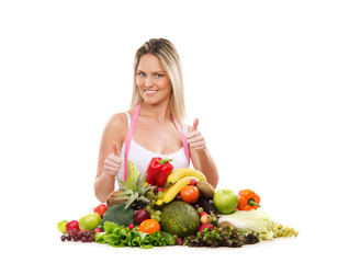A young and sexy blond woman and a pile of fruits