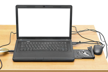 laptop on a table with an open drive