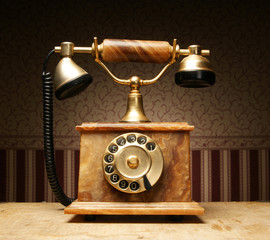 A beautiful old telephone on a vintage background