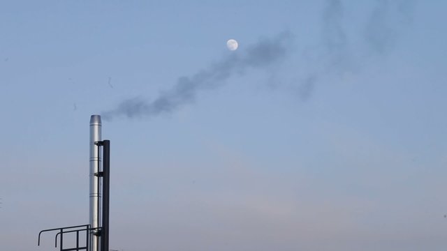 Smoky chimney by the moon, blur.