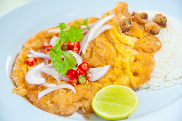 Hot rice with omelet, pork, green herbs and chili sauce