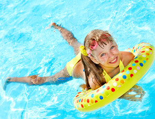 Child playing in swimming pool.