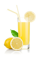 Lemon juice glass and fresh lemons