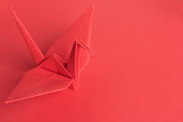 Red Paper Crane on a red background