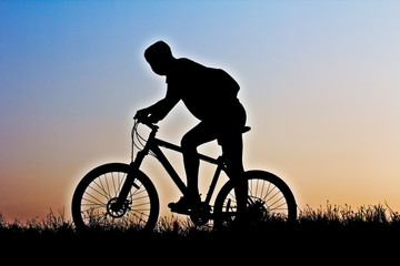 Fototapeta na wymiar A silhouette of a cyclist