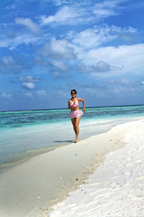 Fototapeta na wymiar Beautiful fashion asian girl playing water in Maldive beach near