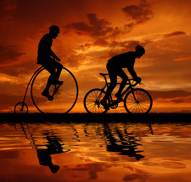 silhouette cyclists on bicycles in the sunset