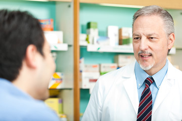 Fototapeta na wymiar Customer asking advice to a pharmacist