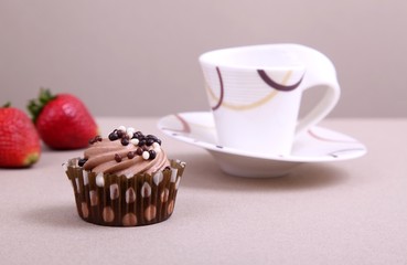 chocolate cupcake with cup of coffee