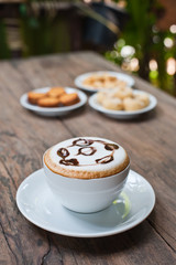 coffee cup with snack on wood table