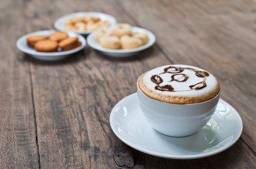 coffee cup with snack on wood table
