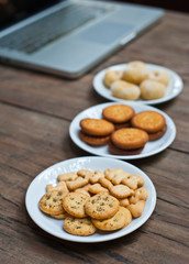 Laptop with snack on wood table