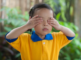 Little girl closing her eyes