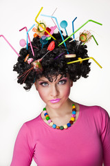 Portrait of a  female isolated with lollipops in the hair