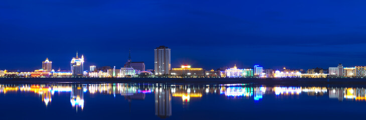 Panorama of the night city in neon lights