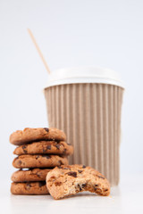 Fototapeta na wymiar Five cookies and an half eaten cookie and a cup of coffee placed