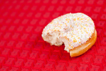 Half doughnut on a red tablecloth