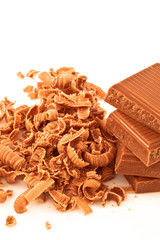 Many chocolate shavings beside a pile of chocolate