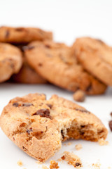 Tasted cookie in front of a stack of cookies