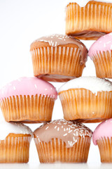Close up on eight muffins with icing sugar placed in pyramid