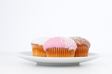 Muffins with icing sugar on a white plate