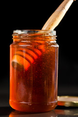 Honey full jar with a honey dipper