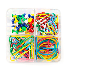 Box with multicolored of pushpins and paperclips