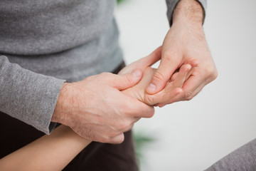 Physiotherapist massaging a hand