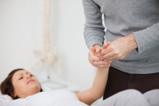 Physiotherapist massaging a painful hand