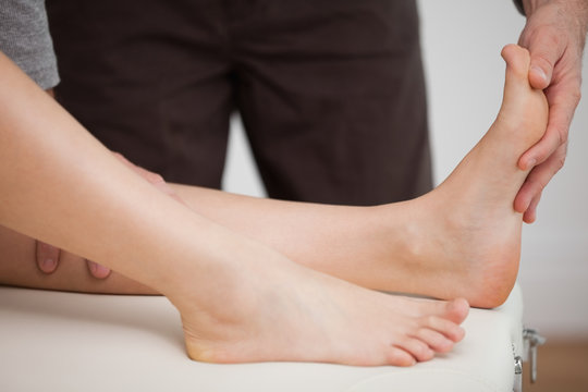 Physiotherapist manipulating the foot of a patient