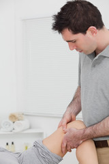 Chiropractor massaging a knee
