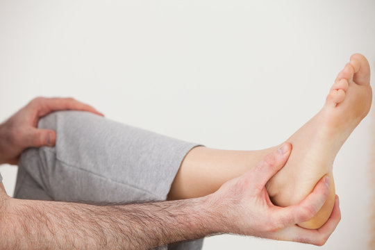 Chiropractor holding the heel of a patient