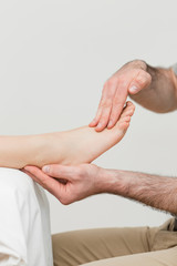 Fototapeta premium Practitioner holding the foot of a patient