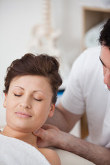 Fototapeta premium Woman being massaging her head while raising it