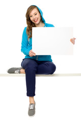 Female teenager with blank poster