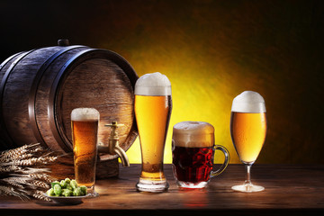 Beer barrel with beer glasses on a wooden table.