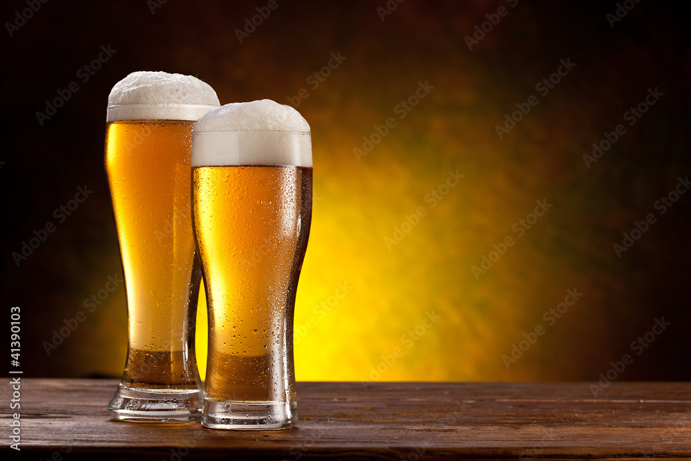 Wall mural beer barrel with beer glasses on a wooden table.