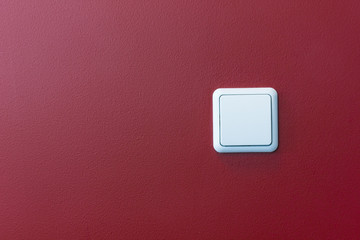 plastic light switch in the  red  wall