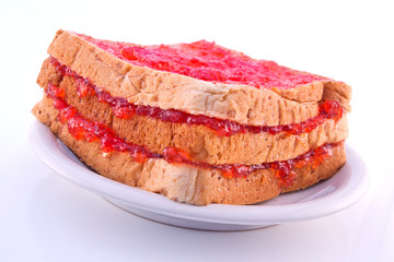 Slices of bread with strawberry jam on plate