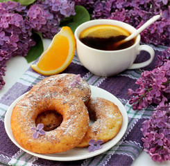 Sweet donuts and tea with orange