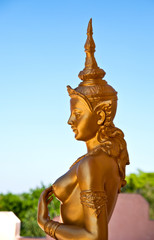Fototapeta na wymiar Female golden guardian angel at the temple, Thailand.